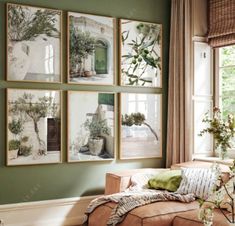 a living room with green walls and pictures on the wall above the couch in front of it