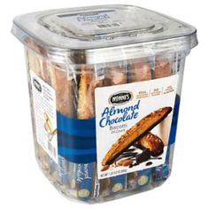 an open plastic container filled with assorted chocolate covered cookies and frosted almonds