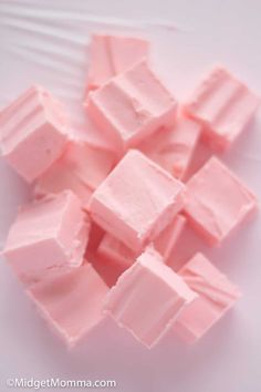 pink marshmallows sitting on top of a white plate