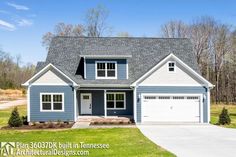 a blue and white house with two garages