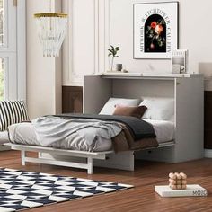 a white bed sitting on top of a wooden floor