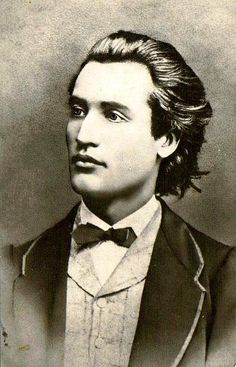 an old black and white photo of a man in a tuxedo