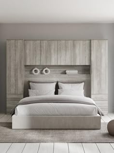 a large bed sitting in the middle of a bedroom next to a wooden headboard