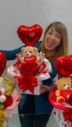 a woman is holding several valentine's day teddy bears