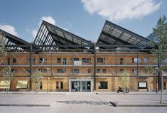 a large building with scaffolding on the front and side of it's roof