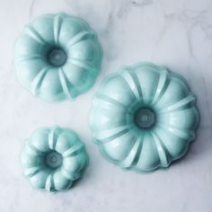 three blue dishes sitting on top of a white counter