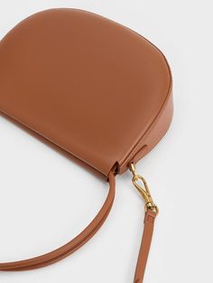 This product is made with at least 20% sustainable materials by weight. CHARLES & KEITH uses recycled, degradable, organic, and water-based materials in our eco-conscious collection. Looking for an alternative to the colour black that is just as chic and versatile? Tan brown is the answer. The simplicity of the Elora curved top handle bag lets the rich and elegant hue shine, making it a striking focal point of any outfit. Pair it with lighter neutral tones to create an eye-catching contrast that will make your entire ensemble stand out. Additionally, the Elora comes with a detachable strap that allows you to play around with styling the bag. Size Chart For Kids, Charts For Kids, Charles Keith, Printables Kids, Eco Conscious, Handle Bag, Sustainable Materials, Neutral Tones, Belt Size