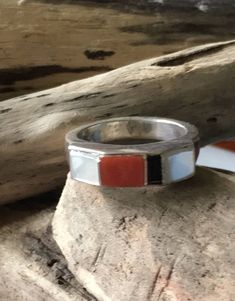 Vintage Native American elegant band style ring with raised angular setting of channel inlaid red coral,mother of pearl and jet stones.The band is 1/4 inch wide and the raised setting is 1 /4 inch high.Has a contemporary look but is vintage. Size 7 1/4 Weight 7.47 Grams Tested Sterling silver Condition new,never worn, from 1980s collection Red Inlay Ring Jewelry, Red Inlay Ring, Red Ring With Inlay, John Meyer, Gold Sign, Navajo Turquoise, Buffalo Ny, Sterling Silver Cross, Silver Cross