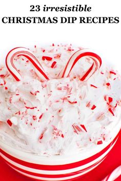 a white cake topped with candy canes on top of a red and white plate