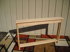 a wooden table sitting on top of a rug