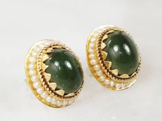 These Vintage Chrysoprase Earrings are beautiful! They have wonderful color and style. Each earring showcases one oval cabachon green chrysoprase stone measuring approximately 8 x 10 mm with a look similar to green jadeite earrings. The stones are surrounded by seed pearls in a halo style. The earrings have post backs and are marked 14k. They are in nice vintage condition and are ready to be worn and enjoyed. These earrings are lovely and sophisticated and the color combination is rich. Chrysopr Elegant Green Cabochons As Gifts, Elegant Green Cabochons For Gifts, Green Round Cabochon Earrings, Green Cabochon Round Earrings, Green Oval Cabochon Gemstone Earrings, Green Gemstone Oval Cabochon Earrings, Green Cabochon Earrings For Anniversary, Large Stud Earrings, Statement Rings Diamond