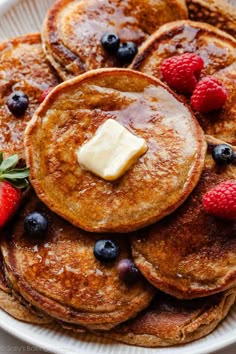 pancakes with butter and berries on a plate