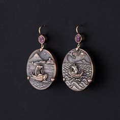 Shakudo is a Japanese mixed metal technique that involved an alloy of copper and gold that was treated to give it a dark black patina. These extraordinary earrings were converted from a pair of antique mixed metal cufflinks (circa 1890-1900). Our jeweler mounted the shakudo pieces in 14k gold and added pink tourmaline surmounts. Each earring measures 1.55 inches from the top of the ear wire to bottom by 1 inch wide. They are in great condition. Materials: 14k gold, Tourmaline. Antique Gold Copper Earrings With Antique Finish, Luxury Collectible Bronze Jewelry, Antique Drop Earrings With Antique Finish, Antique Style Drop Earrings With Antique Finish, Antique Finish Copper Drop Earrings, Elegant Ceremonial Earrings With Oxidized Finish, Elegant Oxidized Earrings For Ceremonial Occasion, Antique Round Engraved Earrings, Bronze Pierced Earrings For Formal Occasions