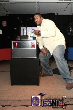 a man standing in front of a podium with his hand on the top of it