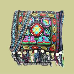 an embroidered purse with tassels and beads on the bottom, in multicolored colors