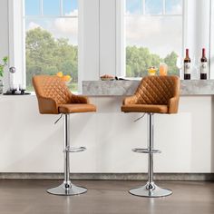 two brown leather bar stools in front of a window