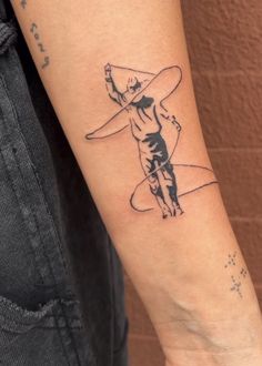 a person with a tattoo on their arm holding a surfboard and pointing at the sky