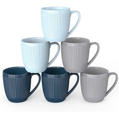 five white and blue coffee mugs stacked on top of each other