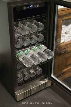 an open refrigerator filled with bottled water