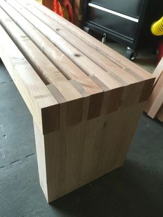 a close up of a bench made out of wood