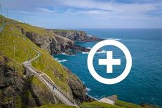 an image of a road going up the side of a mountain with a cross on it