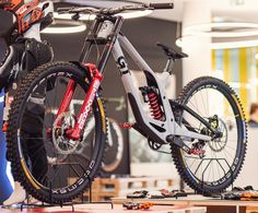 a person standing next to a bike on display