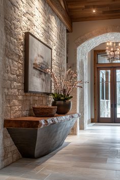 an entry way with a stone wall and potted plants