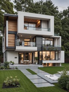 a modern house in the middle of a lush green yard