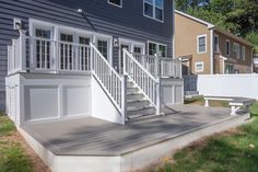 a house with white railings and steps leading up to it