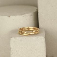 a gold ring sitting on top of a white block