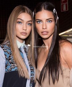 two beautiful young women standing next to each other