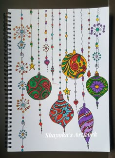 a spiral notebook with ornaments hanging from it