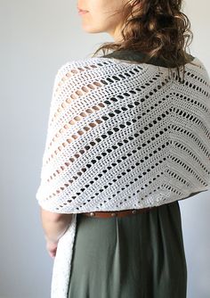 a woman wearing a white crocheted shawl