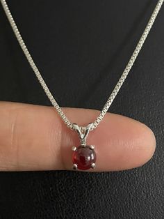 "Genuine Garnet Necklace, Sterling Silver Natural Garnet Pendant, January Birthstone Jewelry NECKLACE FEATURES: Metal: All components are made from solid .925 Sterling Silver Model is wearing 16\" in length solid .925 Sterling Silver Chain Length available: 16\", 18\" or 20\" Measurement: Genuine Garnet Pendant Height 6mm, not including bail Width: 6mm Please visit my storefront to view more of my creations: vonzjewel.etsy.com Thanks a lot for stopping by and supporting my boutique Vonz Jewel" Ruby Necklace With Round Stone Setting, Round Ruby Necklace With Stone Setting, Ruby Round Pendant Necklace For Wedding, Formal Garnet Round Pendant Necklace, Round Garnet Gemstone Necklaces, January Birthstone Jewelry, October Birthstone Jewelry, Fire Opal Necklace, Sterling Silver Locket