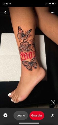 a woman's foot with butterflies and roses tattooed on the side of her leg