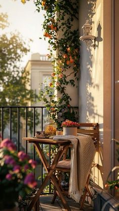 an outdoor table and chairs on a balcony with flowers growing up the side of it