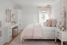 a bedroom with white walls and gold trim on the headboard, dressers, and bed