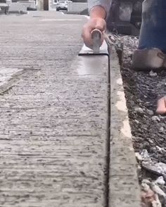 a person using a sandpaper machine on concrete