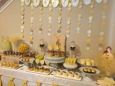 a table topped with lots of desserts and cupcakes on top of it