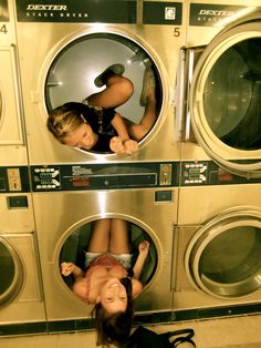 two children are playing in the washing machine