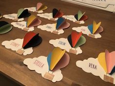 there are many different shapes and sizes of clouds on the table with name tags attached to them