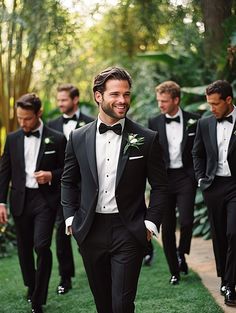 a group of men in tuxedos are walking together