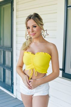 The perfect pop of yellow to pair with denim this spring and summer! Our Sunshine Dreams Crop Top in Yellow has super soft and stretchy material for a cute and comfy look! Cropped strapless top Ribbed with ruffle detail on top lining Synched tie detail on center Runs true to size Erika is 5'3, wears a size 2 and is wearing a small! Yellow Summer Top, Pop Of Yellow, Yellow Clothes, White Skort, Bar Outfit, Yellow Crop Top, Yellow Top, Affordable Clothes, Stretchy Material