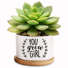 a small potted plant with the words you grow girl on it's side