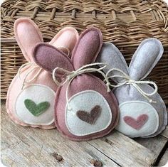 three bunny slippers sitting on top of a wooden table