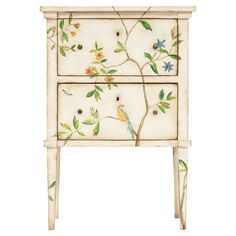 a white cabinet with flowers and birds painted on the front, sitting against a white background