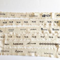 three pieces of cloth with different types of words on them, one is white and the other is black