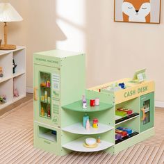 a child's play room with toys and bookshelves in pastel green