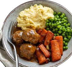 a bowl filled with meatballs, carrots and peas next to mashed potatoes