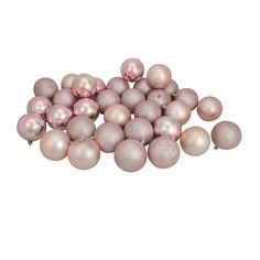 a pile of pink and white ornaments on a white background